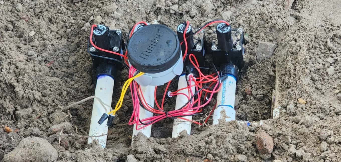 Four new sprinkler zone valves with fresh wiring and a Hunter battery-operated controller installed